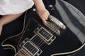 Little babyÃ¢â¬â¢s hand on a black electric guitar. Royalty Free Stock Photo